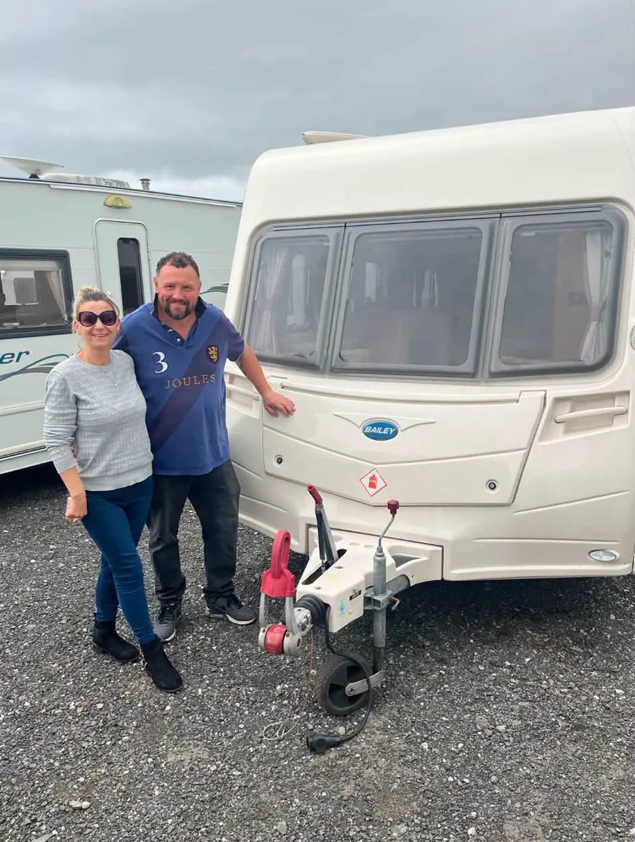 Happy customers with their new caravan